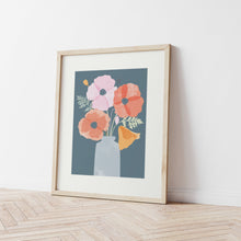 Load image into Gallery viewer, an art print of an illustration of colourful poppies in a vase in a pale wooden frame leaning against a white wall
