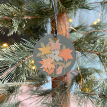 Load image into Gallery viewer, Decorative tag with floral design hanging on a Christmas tree